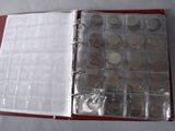 a red binder with a bunch of coins inside of it