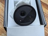 an open box with a camera inside of it on a wooden floor