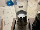 a blender sitting on top of a wooden table next to a coffee maker