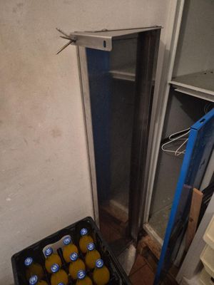 a crate of oranges in the corner of a room