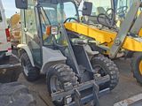 a backhoe of a tractor and a backhoe of a truck