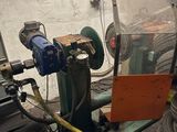 a machine that is working on a tire in a garage