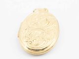 an image of a gold locke with a floral design on it