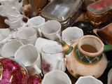 many cups and saucers sitting on a table