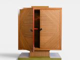 an image of a wooden cabinet with a door open on a white surface