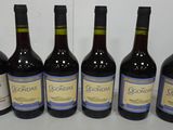 six bottles of wine are lined up on a table