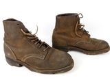 pair of brown leather boots with laces on them on a white background