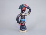 figurine of a man with a bird on his head and a hat on his head