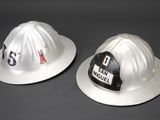 two fire hats that are sitting next to each other