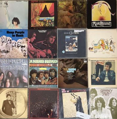 a lot of records on the wall of a room