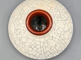 a white plate with a brown bowl on it