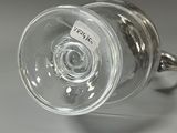 a wine glass that is sitting on top of a table