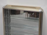 a glass display case in the corner of a room