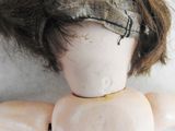 a close up of a doll ' s head and hair