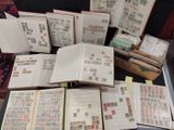 many open books on a table with stamps on them