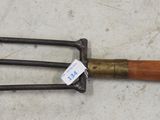 a wooden handled fork with a wooden handle on the floor