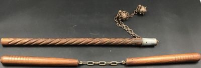 an image of a pair of wooden canes and a chain on a table