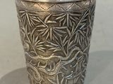 a silver cup that is sitting on a table