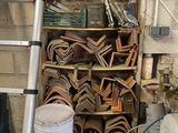 a ladder leaning against a brick wall next to a pile of wood