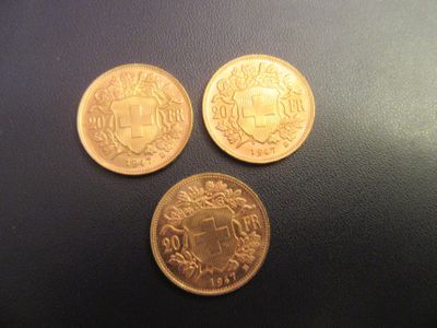 three different coins sitting on top of a table next to each other