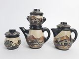 three pieces of pottery that are sitting on a table