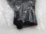 a plastic glove wrapped in plastic on a white surface