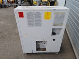 a small refrigerator that is sitting outside of a building