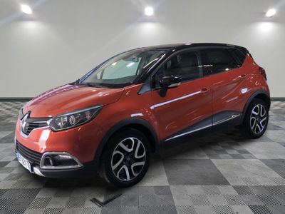 a red car is parked in a room with a checkered floor