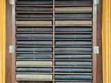 a large wooden cabinet with a lot of books on it
