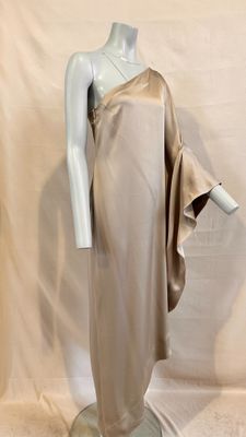 an image of a mannequin wearing a beige dress on a stand