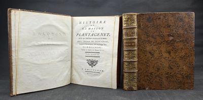 an old book opened to reveal a page of text on a black background
