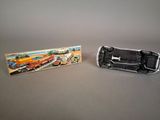 two toy cars that are sitting next to each other on a table
