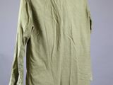 the back of a green shirt on a mannequin mannequin stand