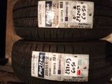 two tires are stacked on top of each other on a shelf
