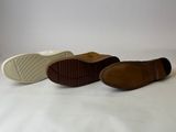 three pairs of shoes are lined up on a white surface