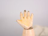 a small wooden hand that is sitting on a table