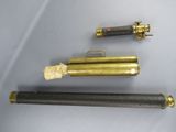 three different types of brass pipes on a white surface