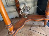 a wooden table with a metal figurine on top of it