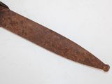 an old rusty knife with a black handle on a white surface