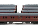 three red train cars are lined up on a white surface