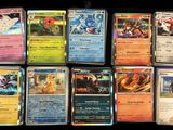 a lot of different pokemon cards on the table