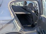 a car with the door open sitting in a parking lot
