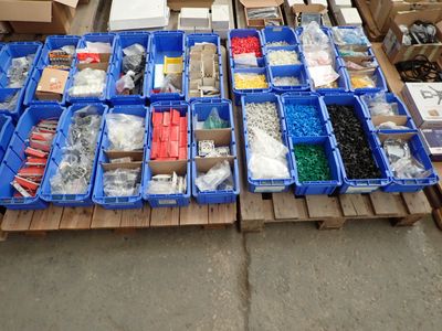 boxes of assorted materials are stacked on a pallet in a warehouse