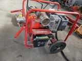 a red machine that is sitting in the garage