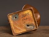 an antique bronze figurine of a dog with a tag on it ' s face