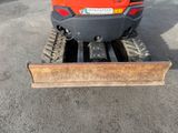 a snow plow that is parked in the parking lot