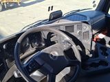 a view of the inside of a truck from the driver ' s seat