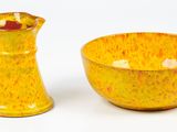 a yellow bowl and a yellow pitcher sitting next to each other