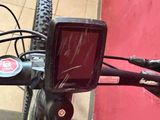 a close up of a bicycle handlebar with a red wall in the background