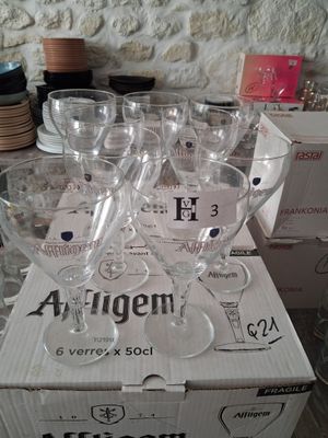 several empty wine glasses sitting on top of a box on a table